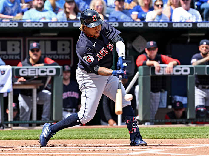 Apr 10, 2022; Kansas City, Missouri, USA; Cleveland Guardians third baseman Jose Ramirez (11) hits an RBI single during the first inning against the Kansas City Royals at Kauffman Stadium.